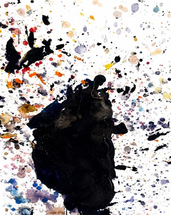 Black central mass surrounded by fine multicoloured splatter