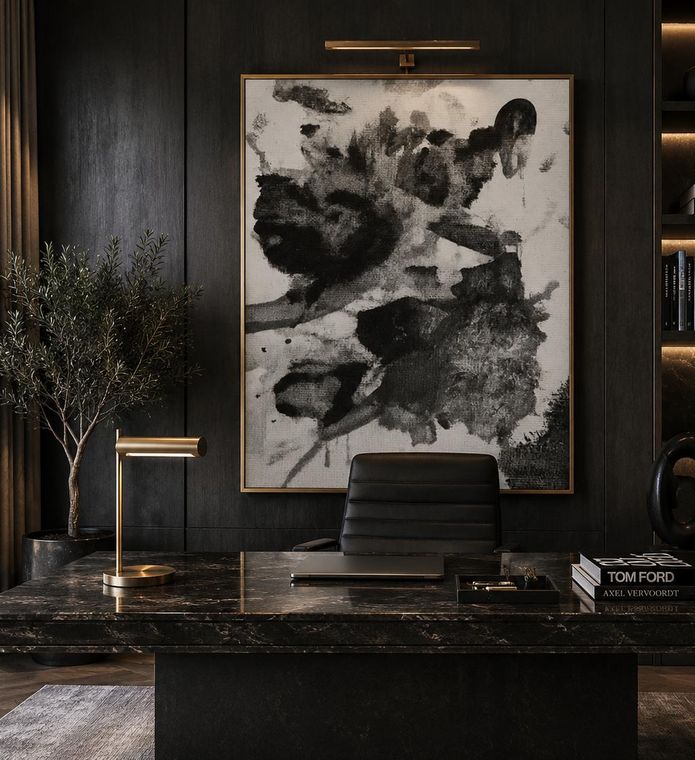 Monochrome ink artwork on a dark panelled wall above a stone console