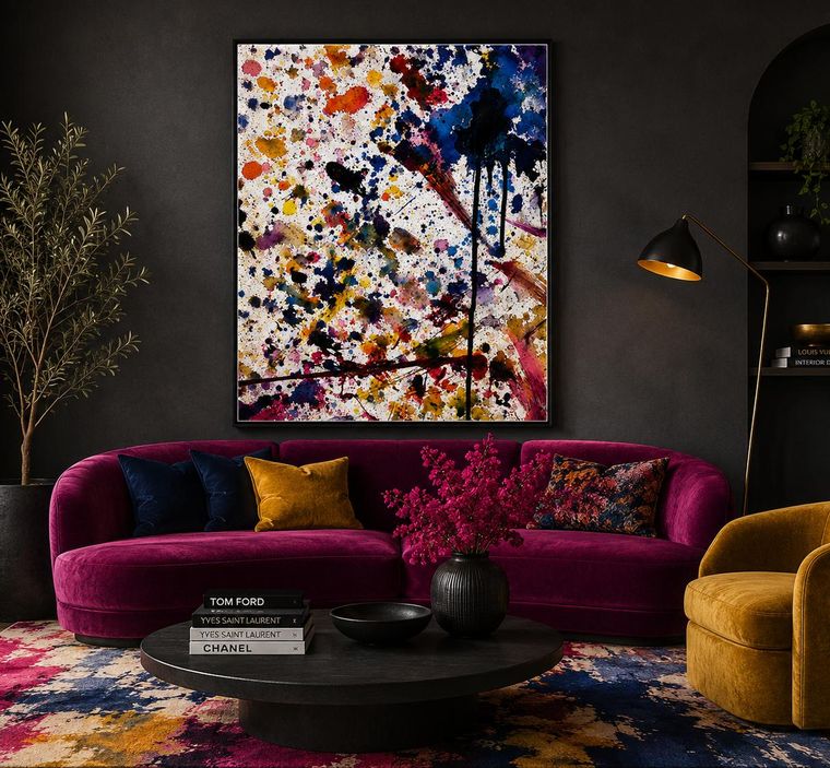 Large multicoloured splatter artwork above a magenta velvet sofa in a dark lounge