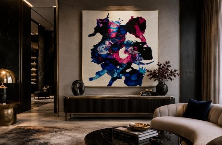 Blue and magenta abstract artwork in a dark contemporary lounge