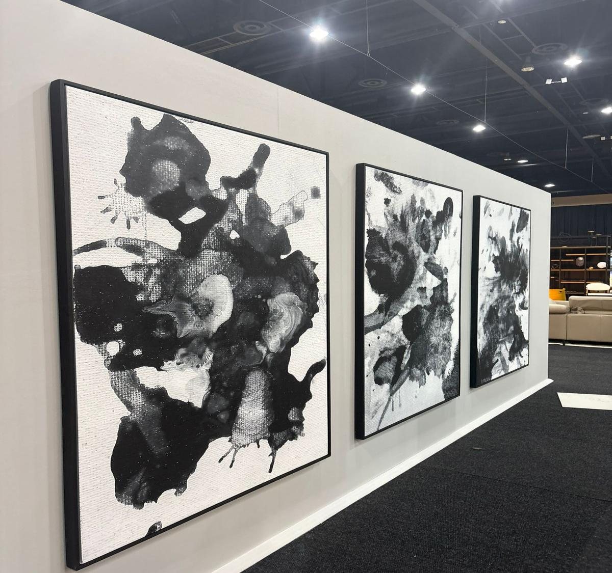 Triptych of large-scale ink artworks installed on a gallery wall